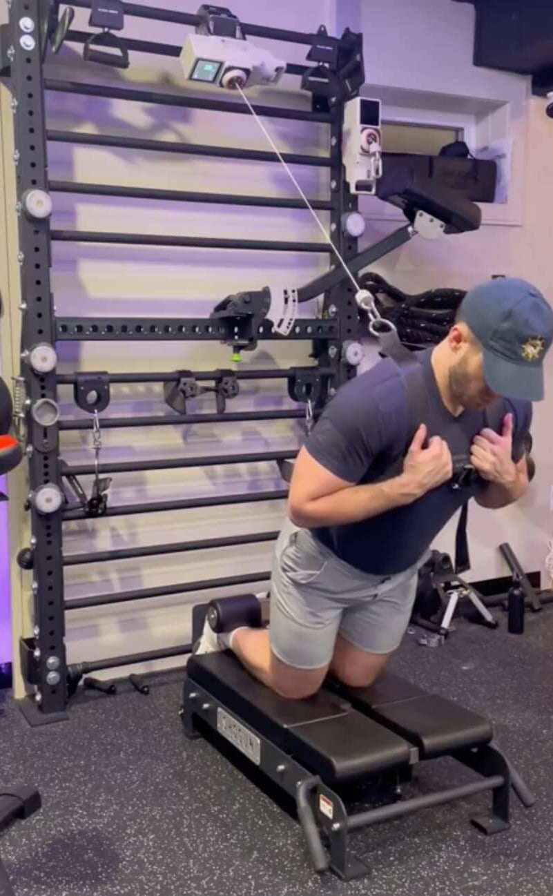 Person using a resistance band machine in a gym setting